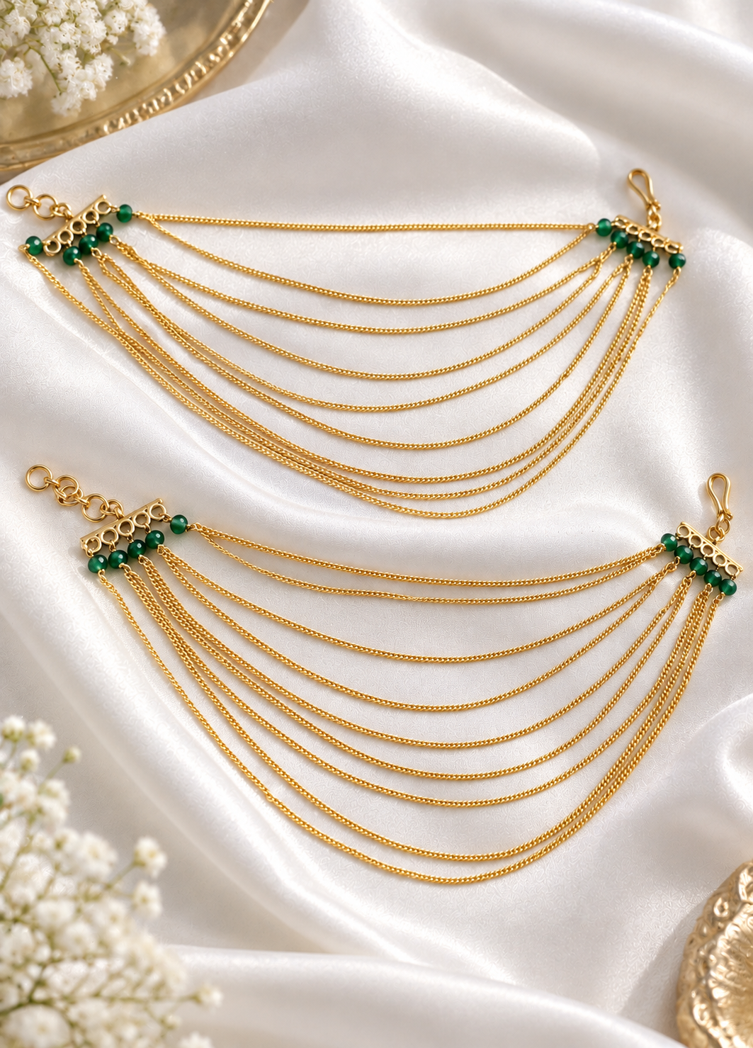 Priyanshi gold saharey earchains with cascading gold chains and green bead accents by Parneet Jewels.